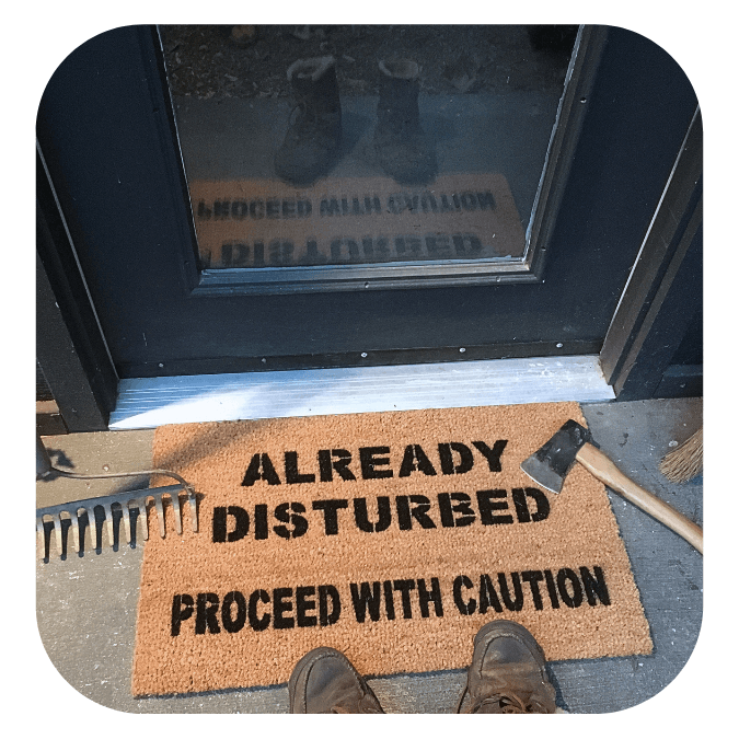 Already disturbed, proceed with caution coir doormat at spooky doorway with a fawn pug and witches broom
