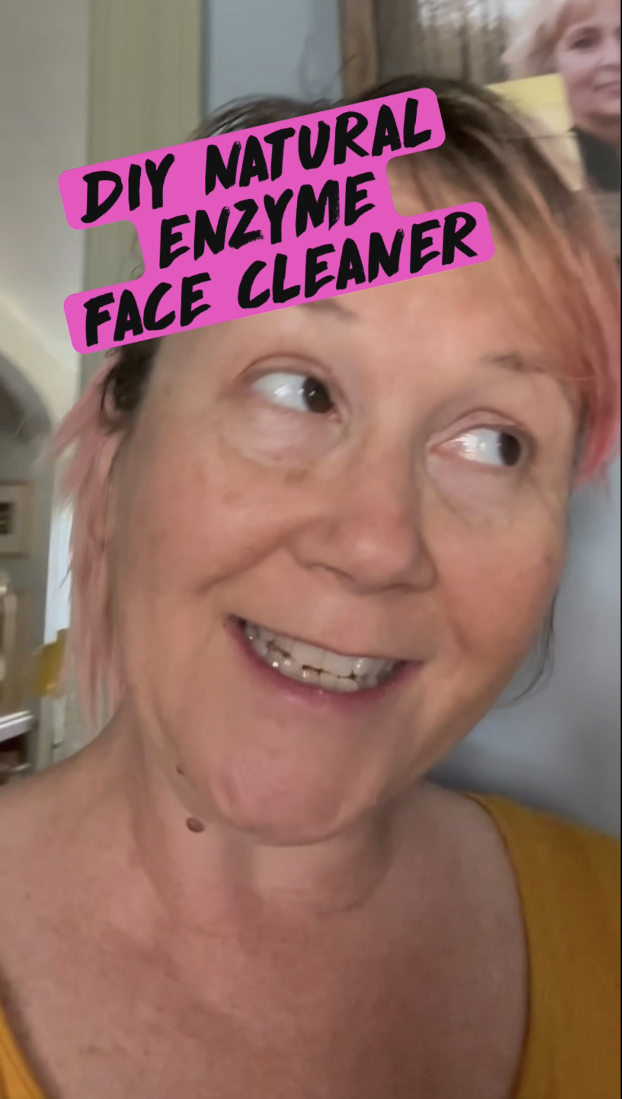 pink haired woman using fresh pineapple as a facial enzyme scrub