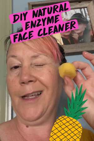 pink haired woman using fresh pineapple as a facial enzyme scrub