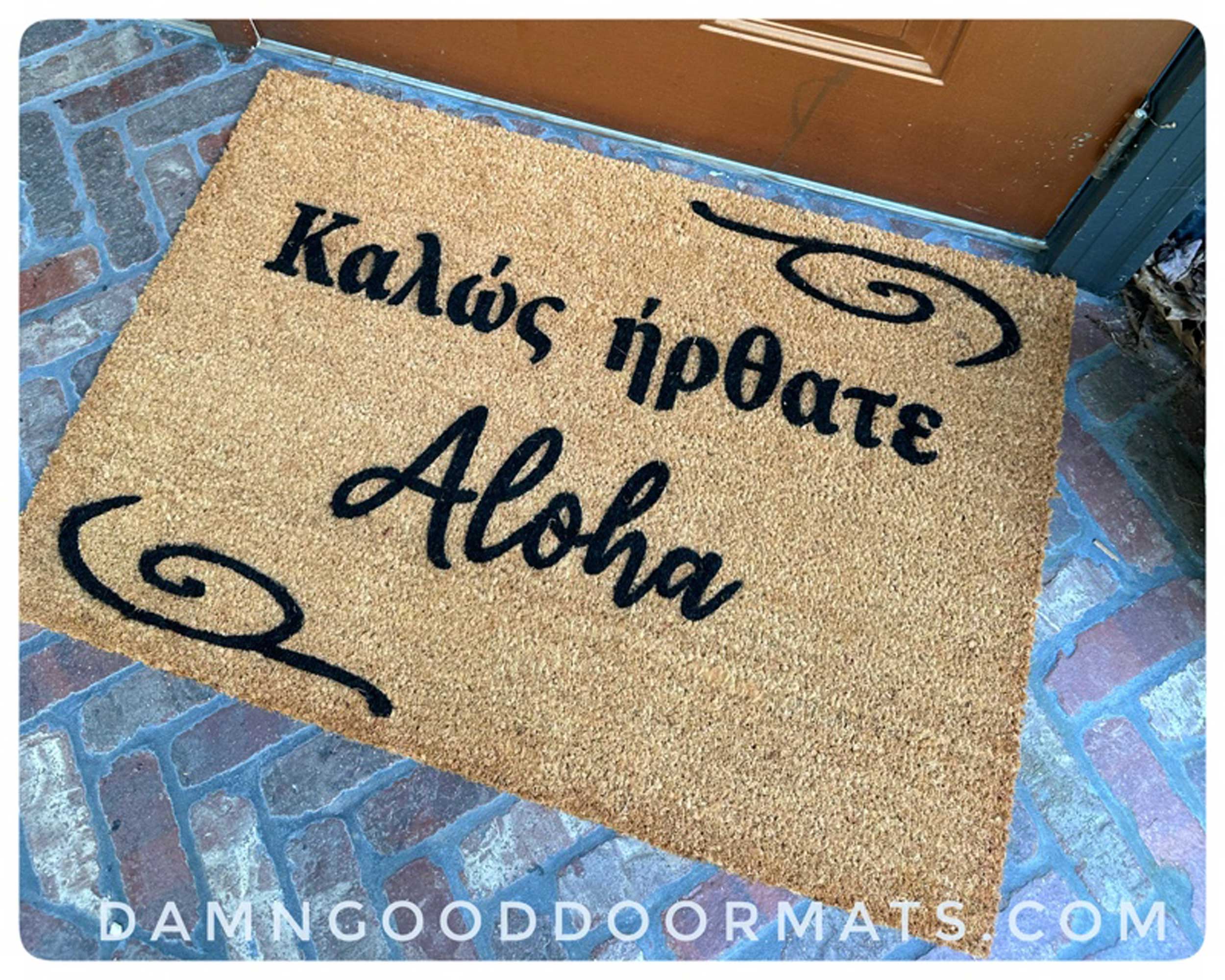 A bilingual welcome mat greeting guests in a heritage language.