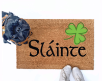 Failte shamrock St Patrick's day coir doormat with a little black pug
