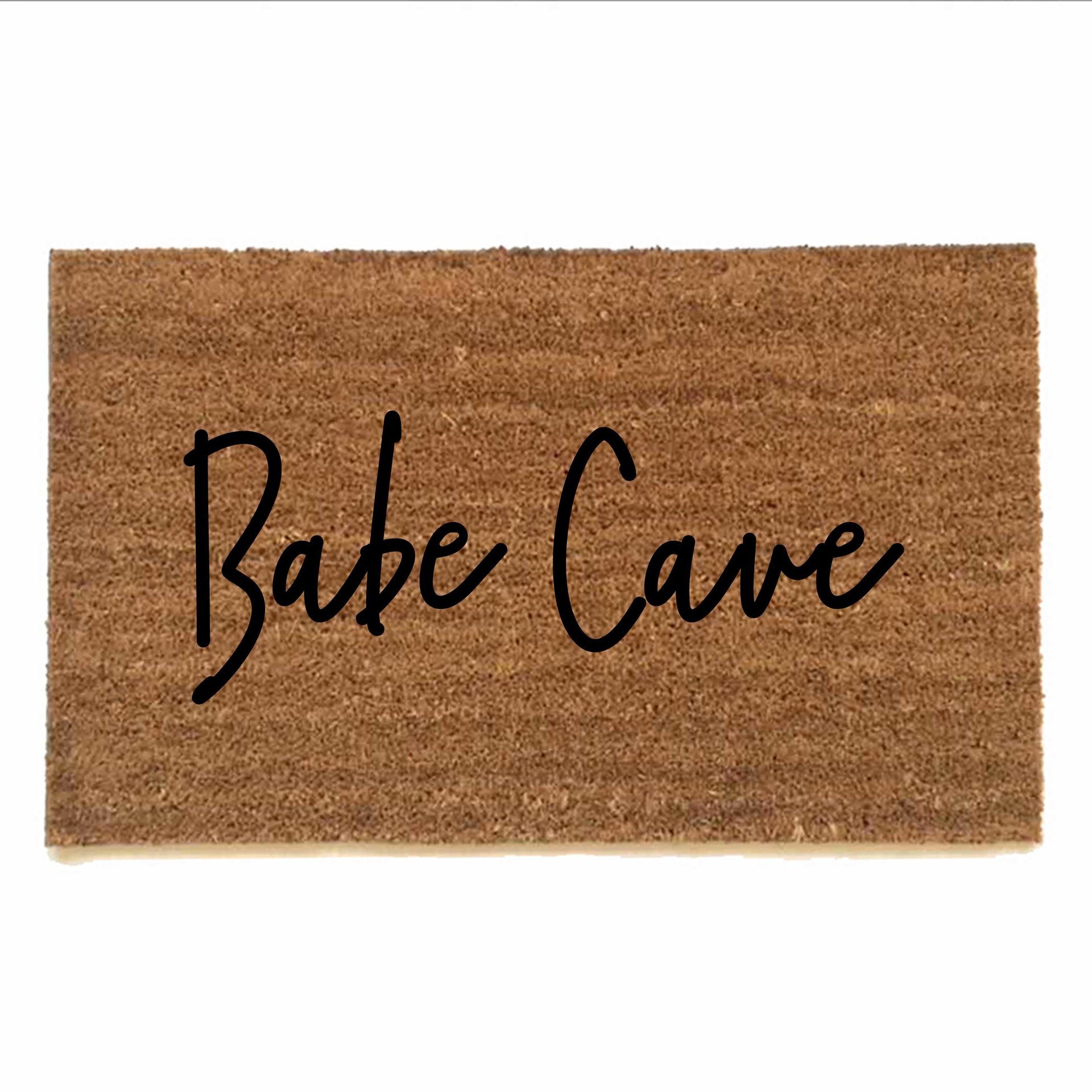 outdoor coir doormat reading "Babe Cave"