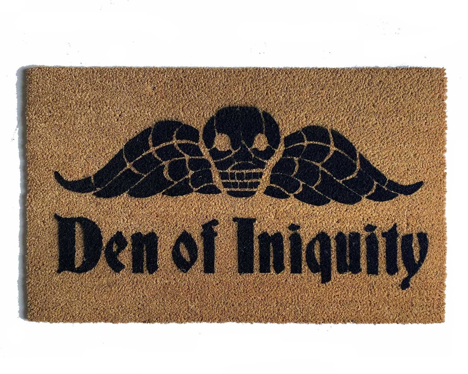 natural coir doormat with gothic skull with wings reading "den of iniquity"