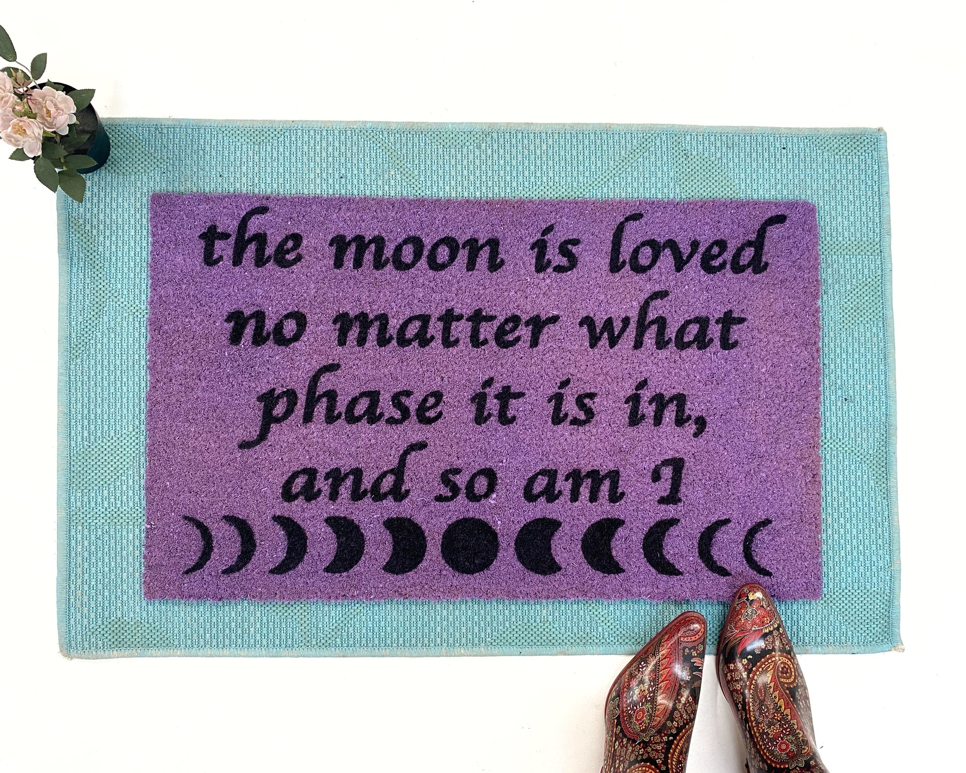 purple coir doormat with moon phase image and saying The moon is loved