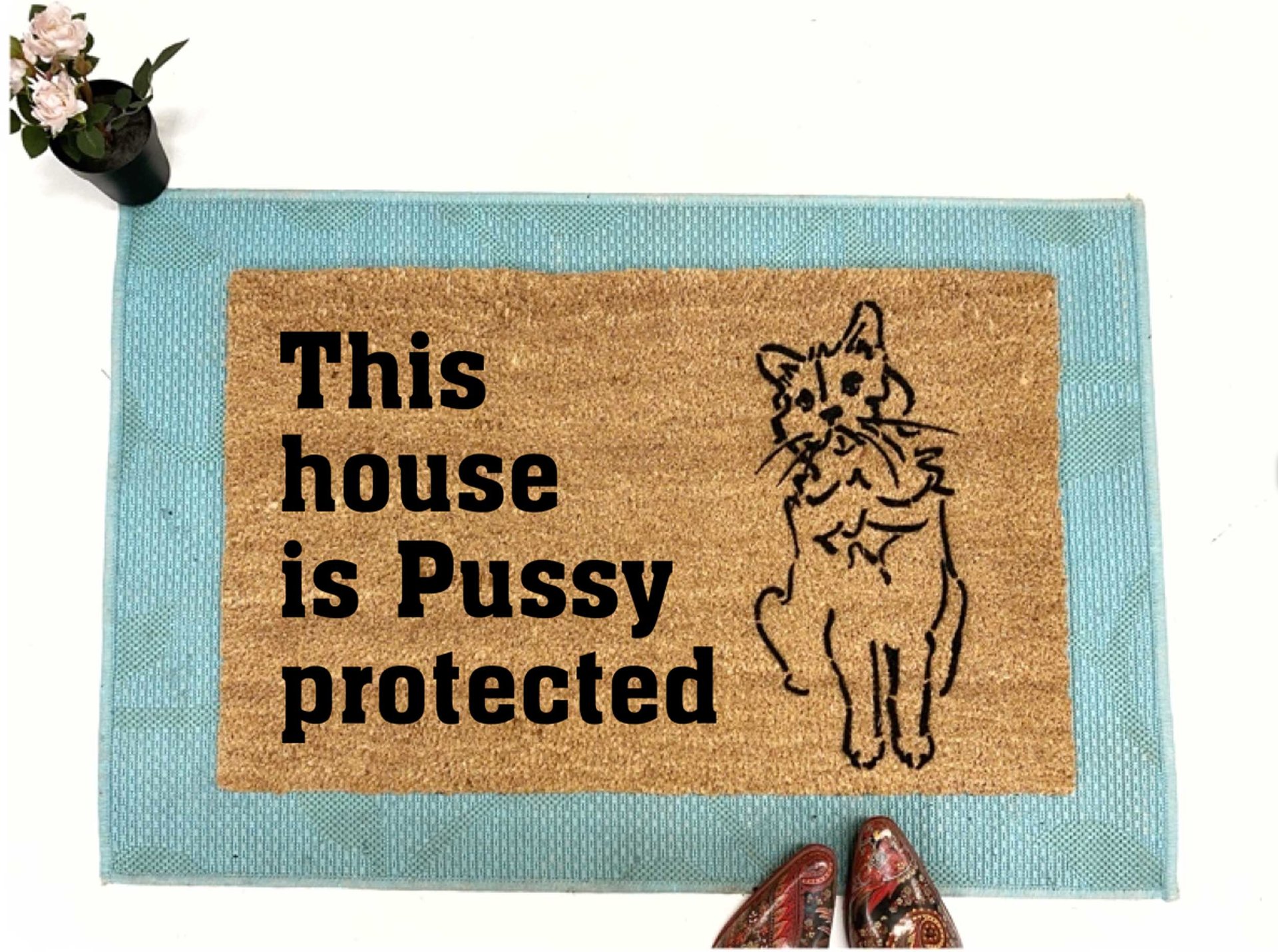coir doormat reading This house is Pussy Protected with a drawing of a cat