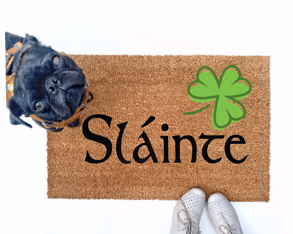 Failte shamrock St Patrick's day coir doormat with a little black pug