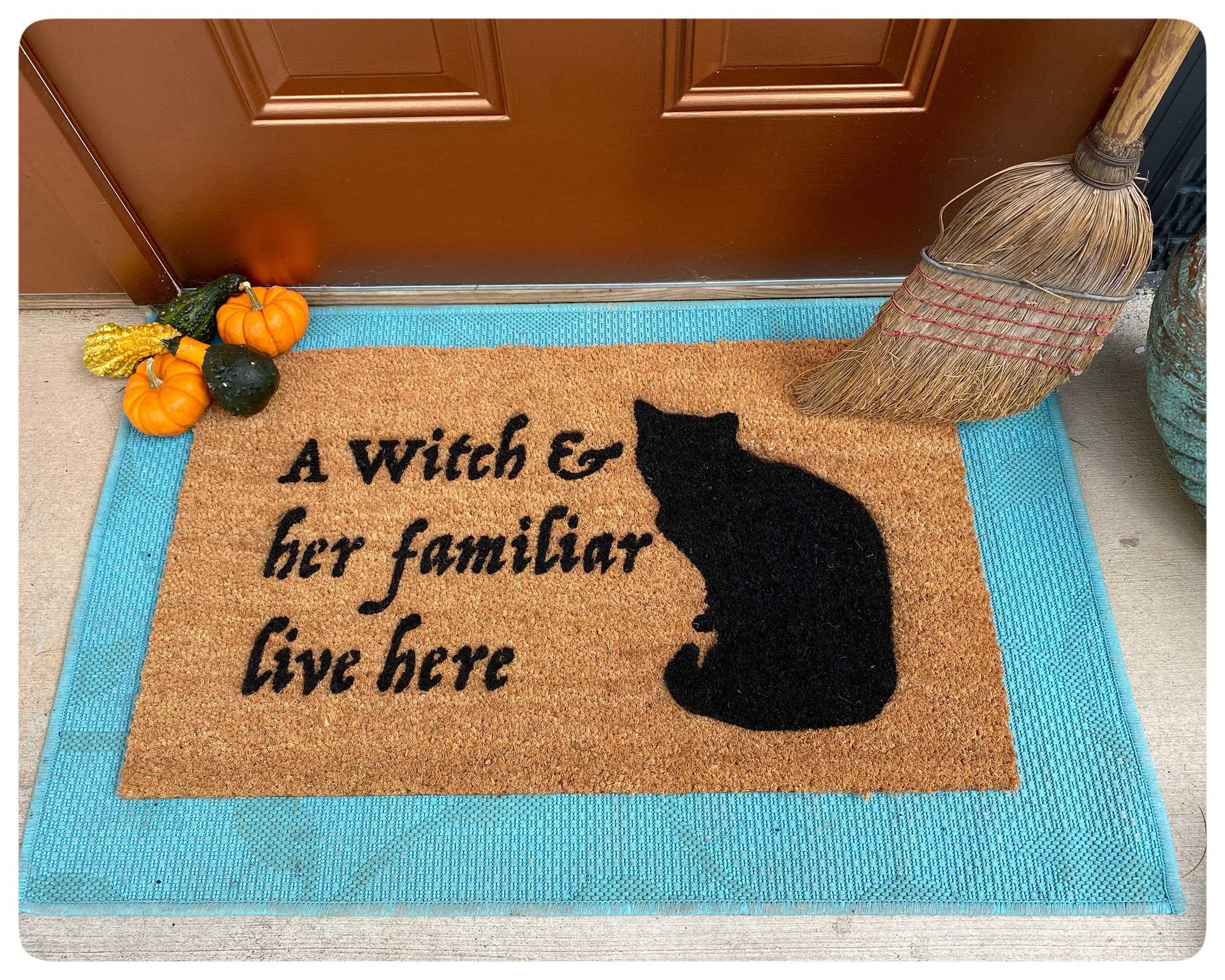 a witch and her familiar live here black cat halloween gothic home doormat