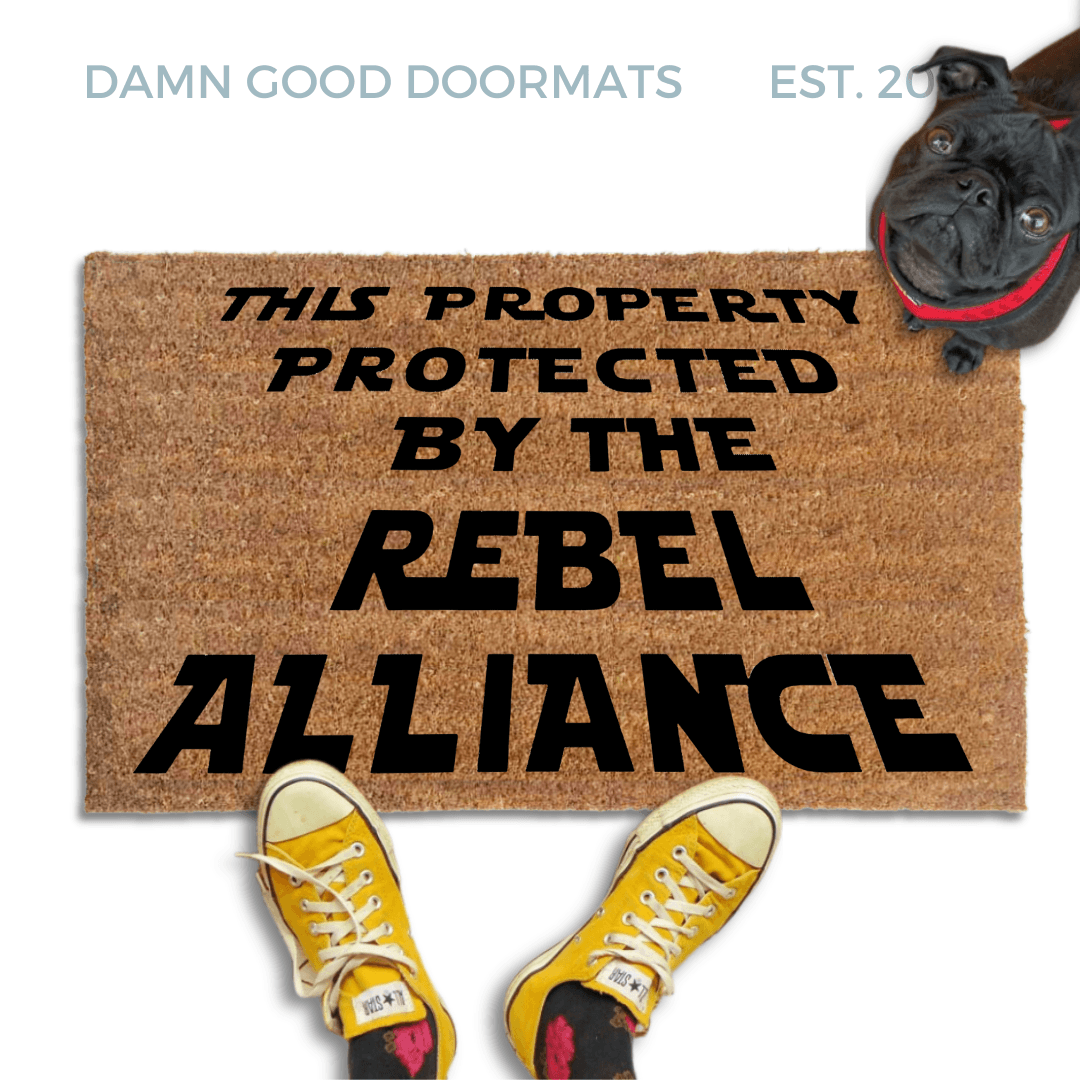 This Property Protected by the Rebel Alliance Nerdy Doormat with black pug in a red collar looking up at someone in yellow fish head converse sneakers