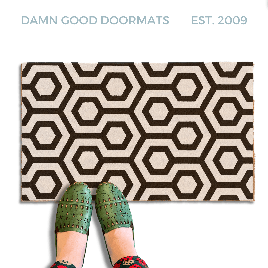 The shining hex carpet pattern printed in black and white on a coir doormat