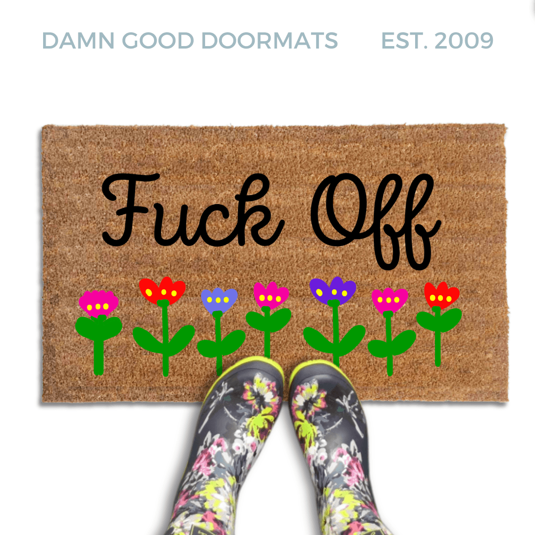 promotional image of a coir doormat reading "fuck off" in cursive with red and purple flowers across the  bottom