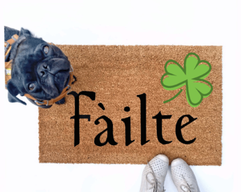 Failte shamrock St Patrick's day coir doormat with a little black pug