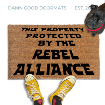 This Property Protected by the Rebel Alliance Nerdy Doormat with black pug in a red collar looking up at someone in yellow fish head converse sneakers