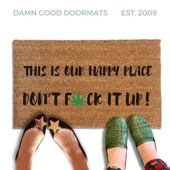 Coir doormat reading "This is our happy place, don't fuck it up," with a green cannabis leaf replacing the U in FUCK. Lifestyle photo shows two pairs of feet standing at the front edge of the mat.