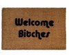outdoor coir doormat with text "welcome bitches" on it